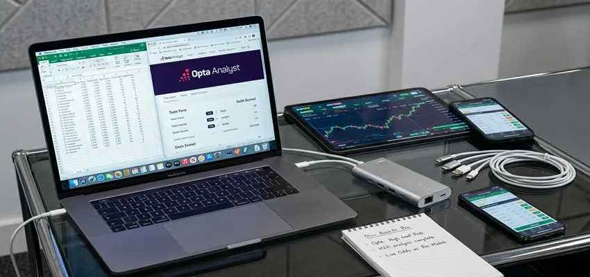 Modern sports bettor using analytics software, mobile apps, and data tools to make informed betting decisions.
